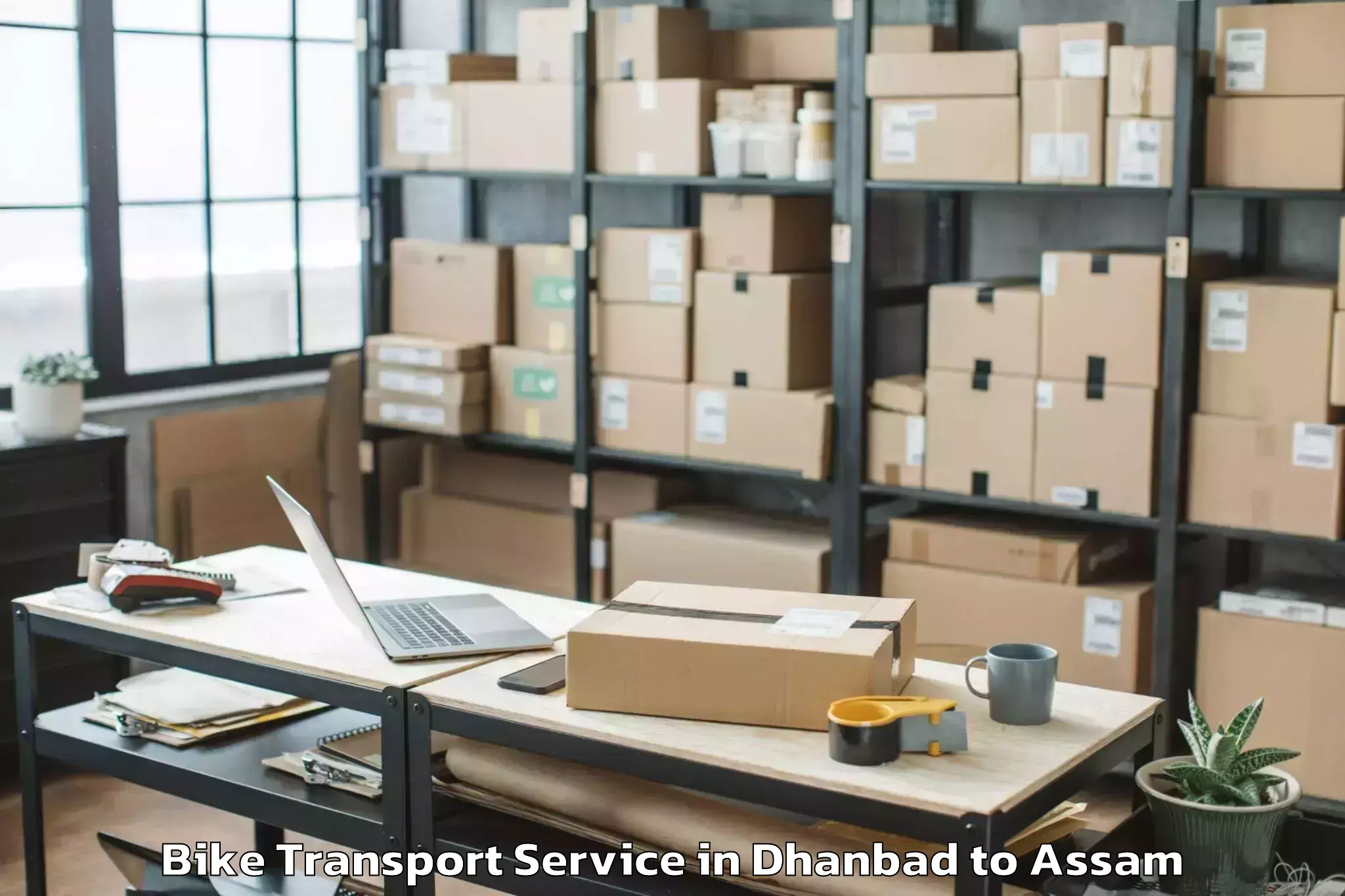 Hassle-Free Dhanbad to Kumbhirgram Airport Ixs Bike Transport